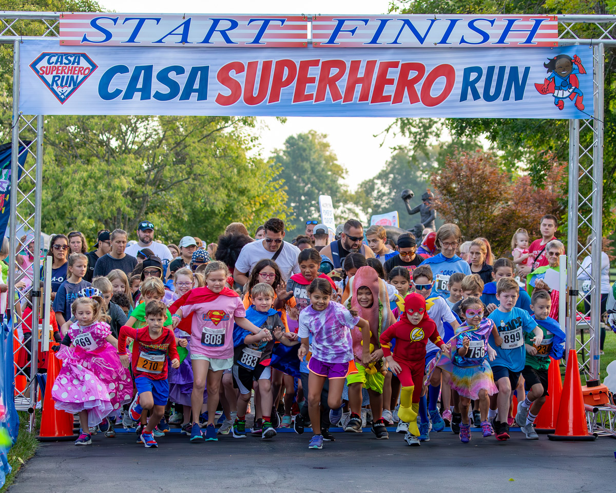Kids running out of the gate at the start of the fun run.