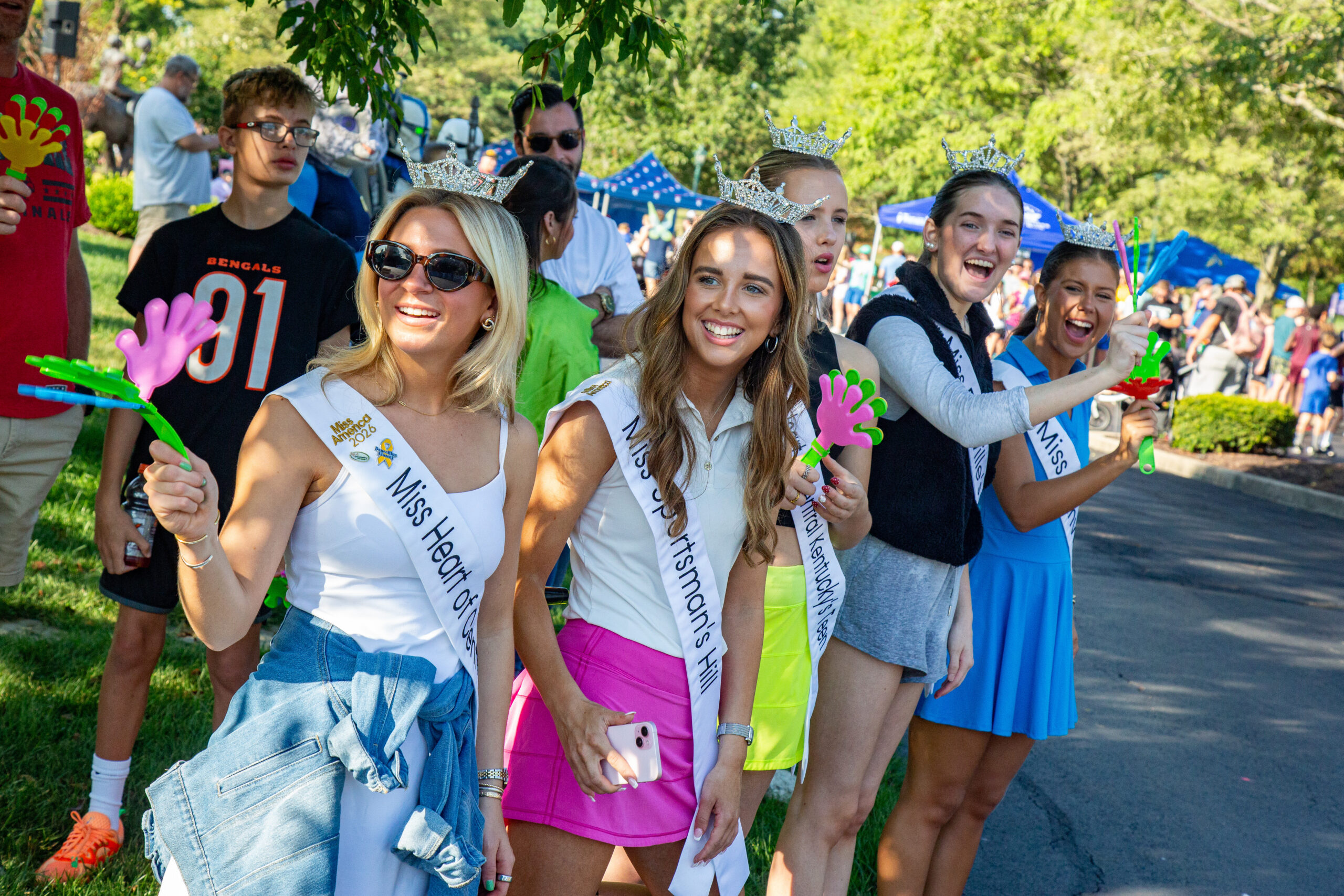 Local pageant winners cheering on the runners.